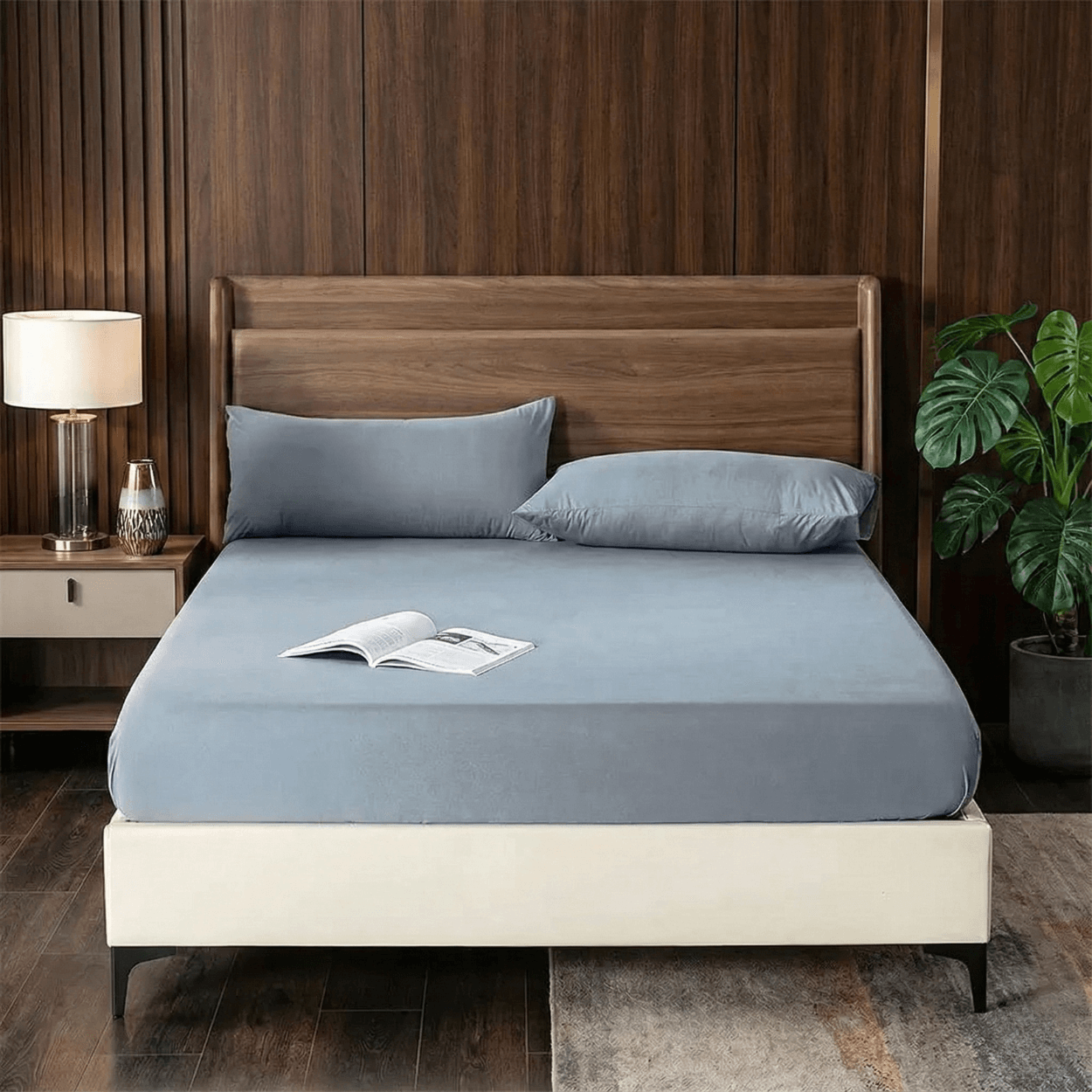Bed with blue bedding and wooden headboard in a bedroom setting