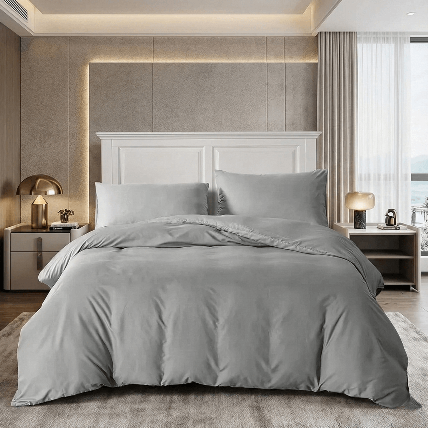 Neatly made bed with gray bedding in a modern bedroom setting.